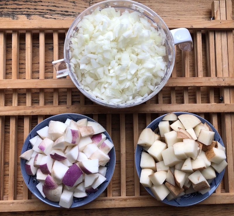 Chopped onions potatoes and turnips for hamburger soup
