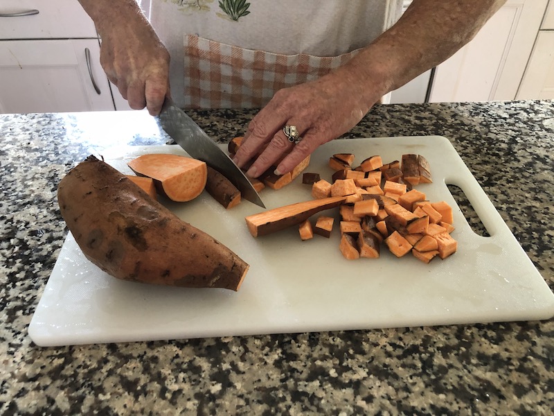 Woman chopping sweet potatoes